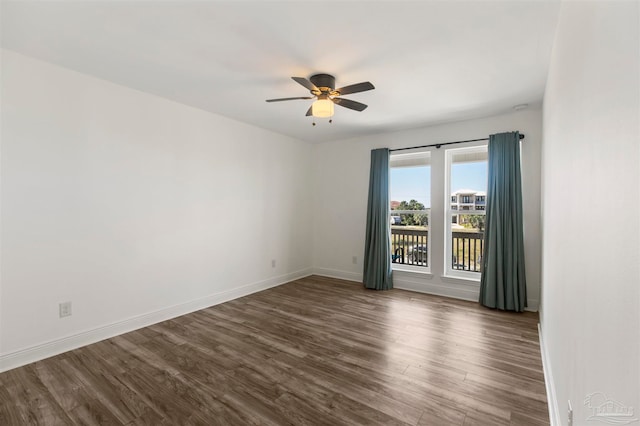 empty room with dark wood-type flooring and ceiling fan