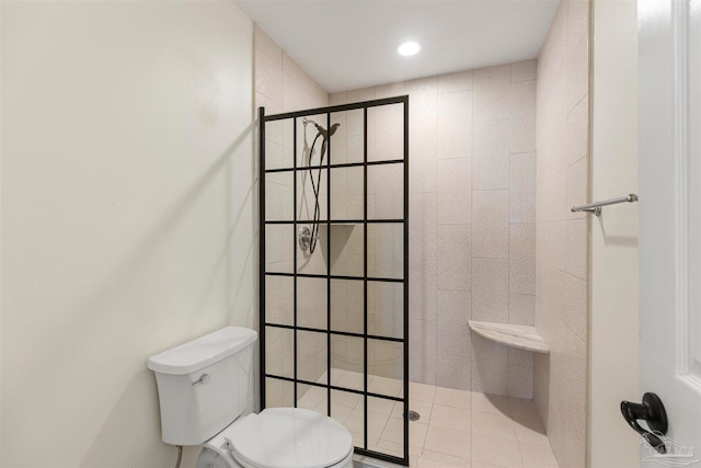 bathroom with toilet, walk in shower, and tile patterned flooring