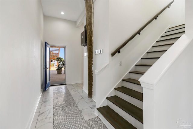 staircase featuring a high ceiling