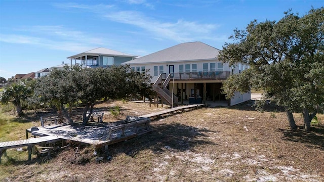 back of house with a wooden deck