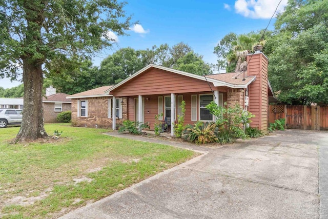 6555 Bellview Pines Pl, Pensacola, FL 32526 - ranch-style home featuring covered porch, a chimney, a shingled roof, brick siding, and driveway