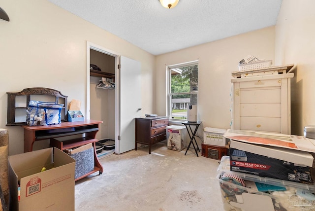 6555 Bellview Pines Pl, Pensacola, FL 32526 - bedroom with unfinished concrete floors, a textured ceiling, and a closet