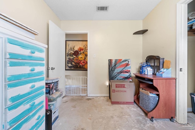6555 Bellview Pines Pl, Pensacola, FL 32526 - bedroom with concrete flooring, a textured ceiling, and baseboards