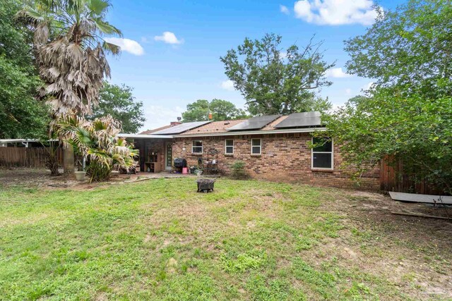 6555 Bellview Pines Pl, Pensacola, FL 32526 - rear view of house featuring brick siding and solar panels