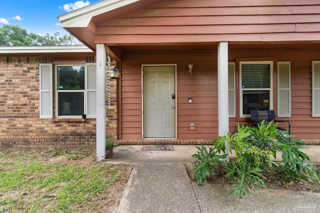 6555 Bellview Pines Pl, Pensacola, FL 32526 - view of exterior entry featuring a porch and brick siding