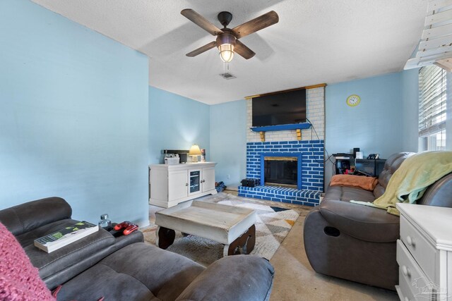 6555 Bellview Pines Pl, Pensacola, FL 32526 - carpeted living area featuring a ceiling fan, a fireplace, and a textured ceiling