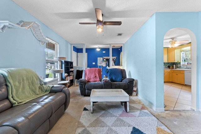 6555 Bellview Pines Pl, Pensacola, FL 32526 - living area with a ceiling fan, light colored carpet, plenty of natural light, a textured ceiling, and arched walkways