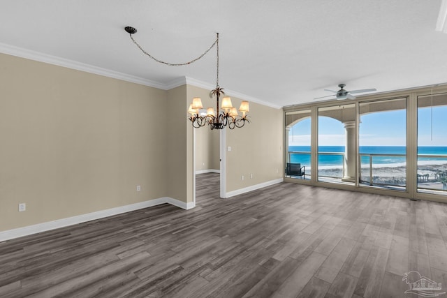 spare room with a beach view, dark hardwood / wood-style flooring, a water view, and crown molding