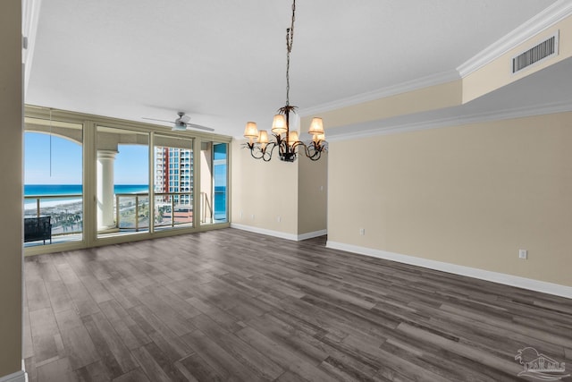 unfurnished dining area with dark wood-type flooring, ornamental molding, a healthy amount of sunlight, and a water view