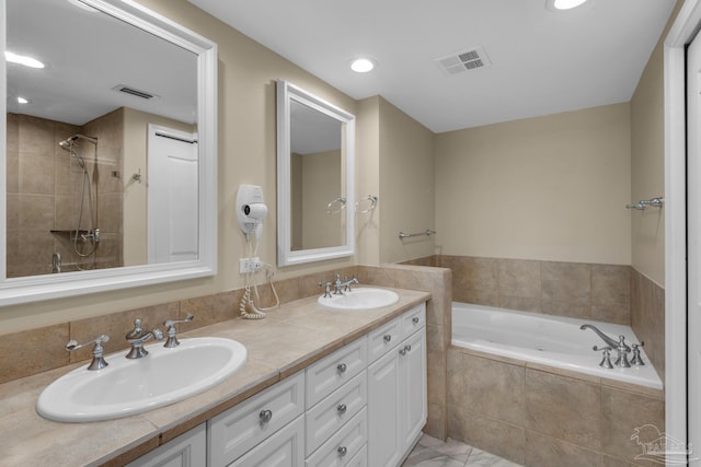 bathroom with tiled bath and vanity