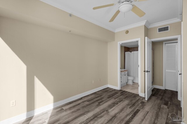 unfurnished bedroom with ceiling fan, ensuite bathroom, ornamental molding, and wood-type flooring