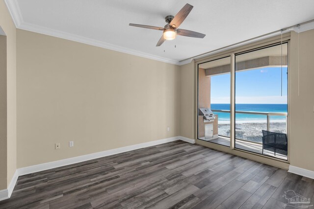 empty room featuring ceiling fan, ornamental molding, dark hardwood / wood-style floors, and a water view