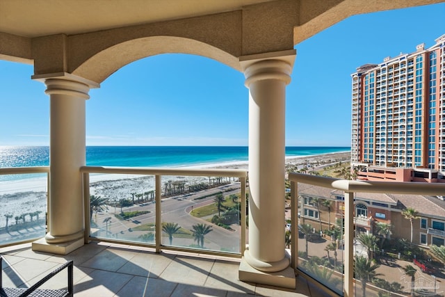 balcony with a beach view and a water view