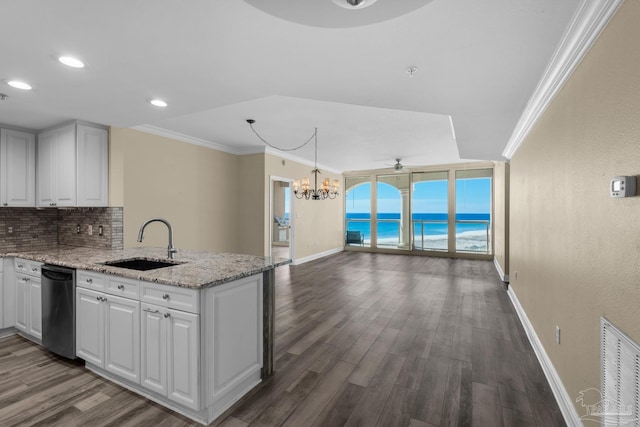 kitchen featuring stainless steel dishwasher, decorative light fixtures, ceiling fan with notable chandelier, white cabinets, and sink