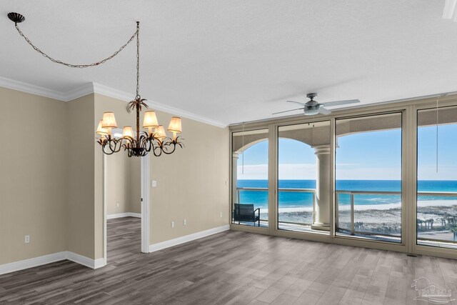 unfurnished room featuring ceiling fan with notable chandelier, ornamental molding, hardwood / wood-style floors, and a water view