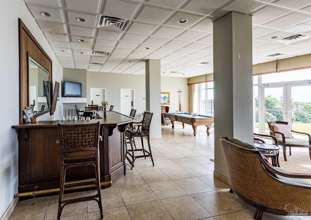 tiled dining area featuring french doors, bar area, a drop ceiling, and pool table