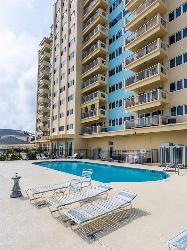 view of swimming pool with a patio area and central AC unit