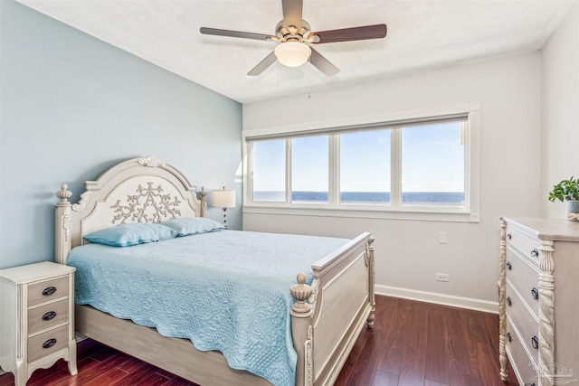 bedroom with ceiling fan and dark hardwood / wood-style floors