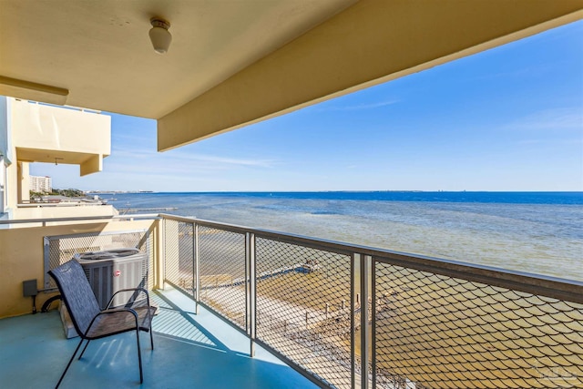 balcony featuring cooling unit, a view of the beach, and a water view