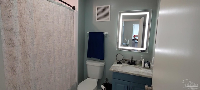 bathroom with toilet, vanity, and a shower with curtain