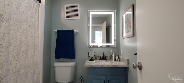 bathroom with toilet and vanity