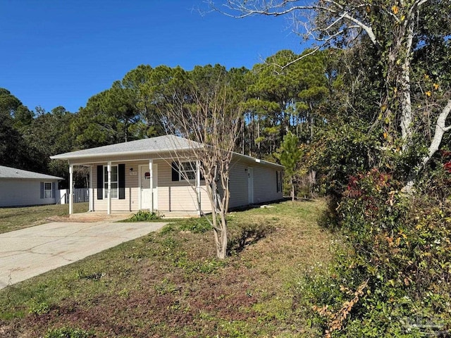 single story home with covered porch and a front yard