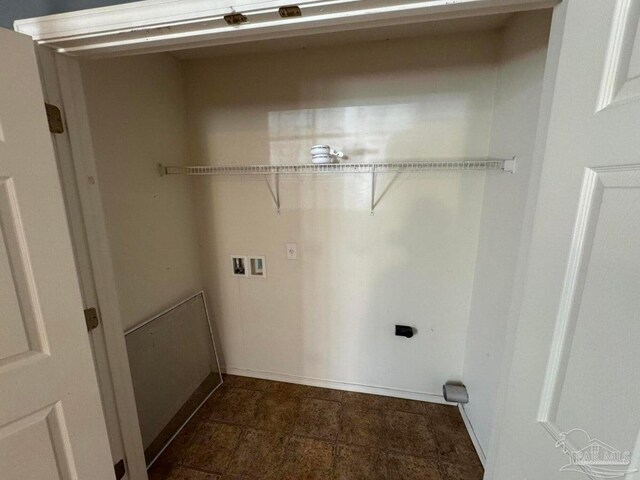 clothes washing area featuring hookup for a washing machine and baseboards