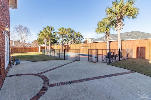 view of patio / terrace with a fenced in pool and a shed