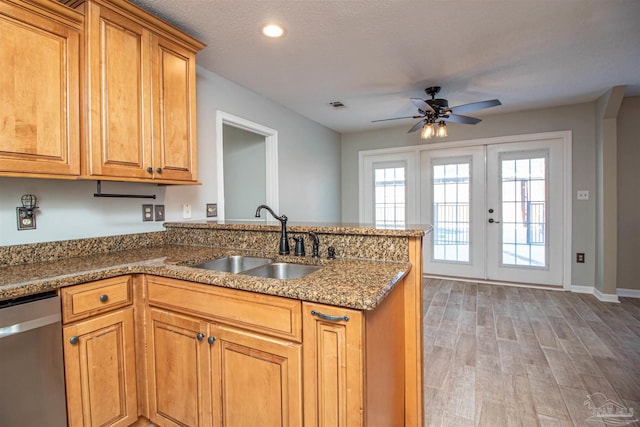 kitchen with dishwasher, french doors, sink, hardwood / wood-style flooring, and kitchen peninsula