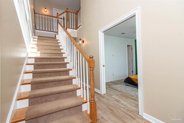 stairway featuring hardwood / wood-style flooring