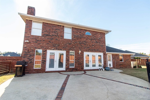 rear view of property featuring french doors and a patio