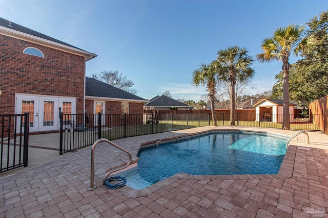 view of swimming pool with a patio and french doors