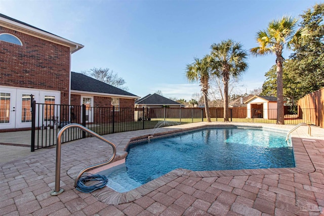 view of swimming pool with french doors and a patio