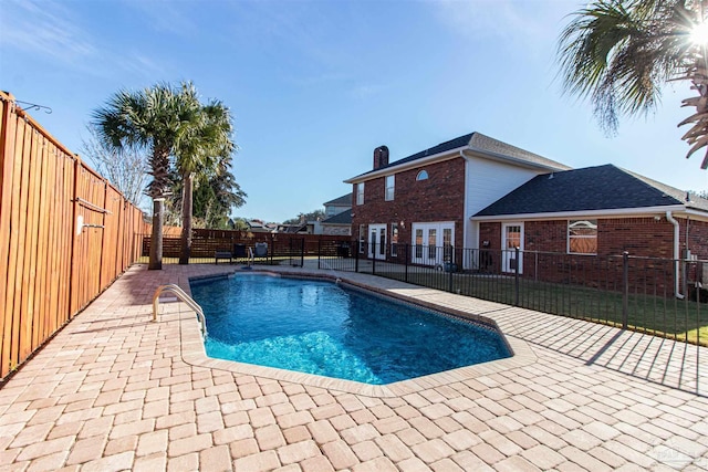 view of swimming pool featuring a patio and french doors