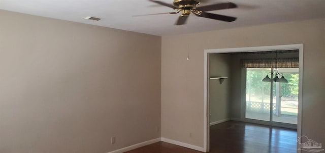 empty room with ceiling fan and dark hardwood / wood-style flooring