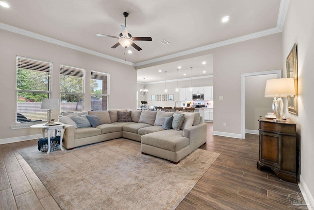 living area with crown molding, baseboards, recessed lighting, dark wood finished floors, and ceiling fan with notable chandelier