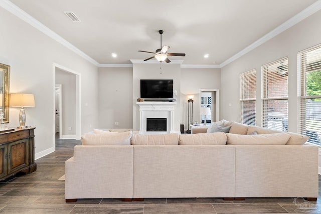 living area with ornamental molding, a fireplace, ceiling fan, recessed lighting, and dark wood-type flooring