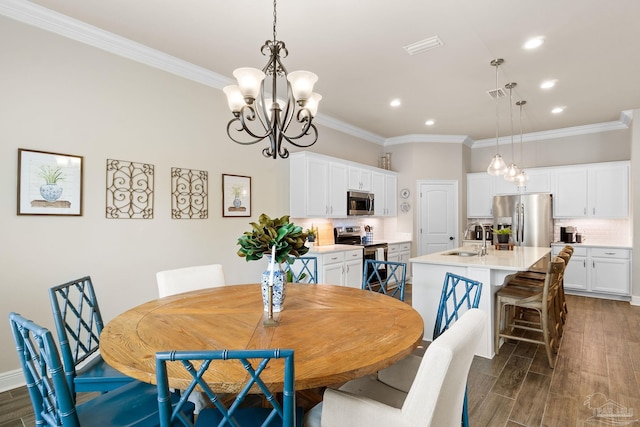 dining area featuring ornamental molding, dark wood-style flooring, recessed lighting, and a chandelier