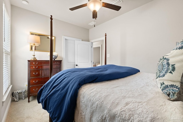 carpeted bedroom featuring ceiling fan and visible vents