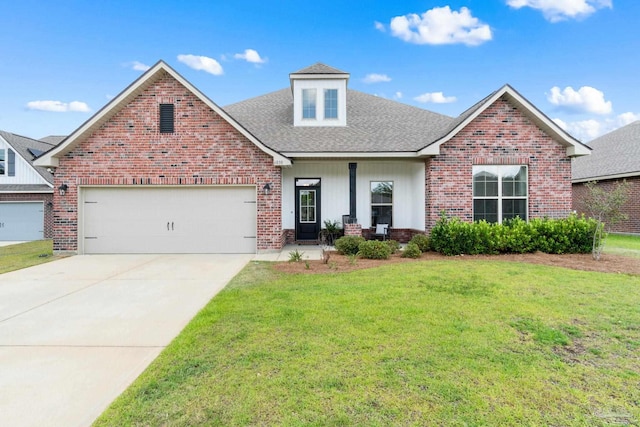 view of front of house with roof with shingles, driveway, brick siding, and a front yard