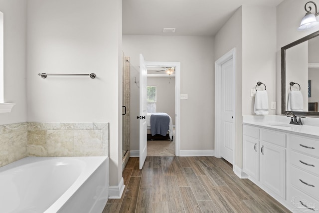 full bath featuring ceiling fan, a bath, visible vents, wood finished floors, and vanity