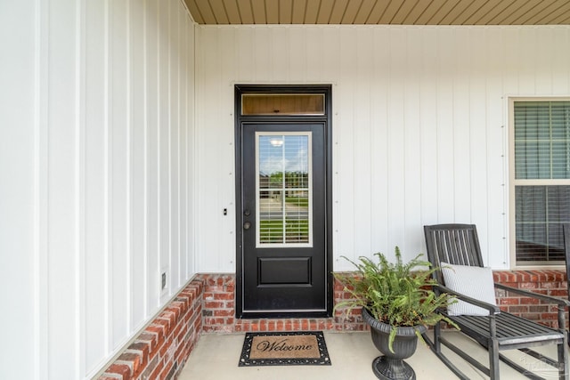 view of exterior entry with brick siding