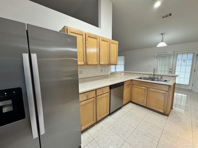 kitchen with sink, hanging light fixtures, stainless steel appliances, light tile patterned flooring, and kitchen peninsula