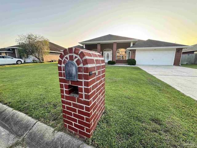 view of front of property with a garage and a lawn