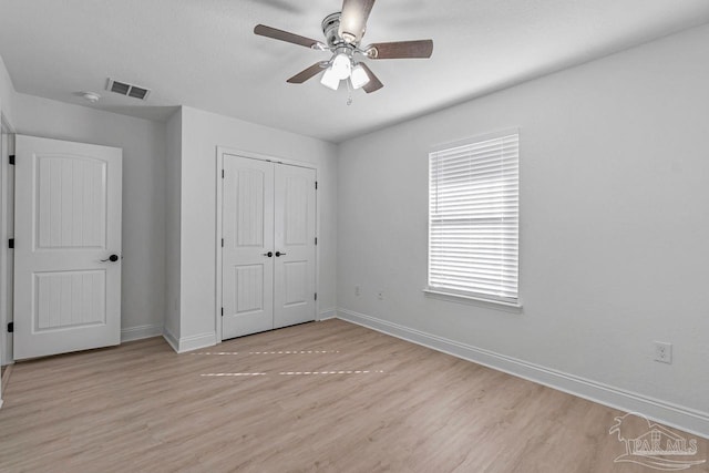 unfurnished bedroom with a closet, ceiling fan, and light wood-type flooring