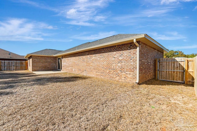 view of side of property featuring a patio area