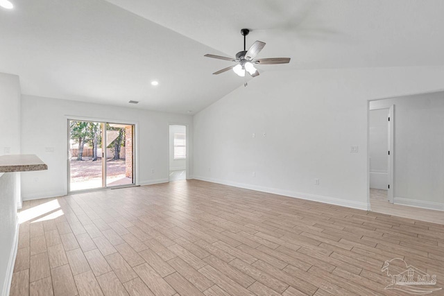 unfurnished living room with ceiling fan, vaulted ceiling, and light wood-type flooring