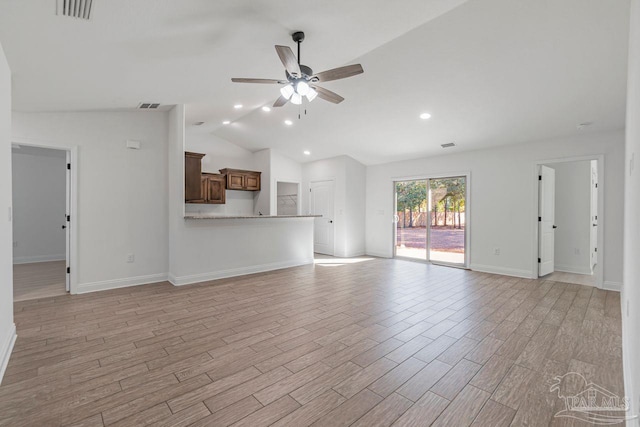 unfurnished living room featuring vaulted ceiling, ceiling fan, and light wood-type flooring