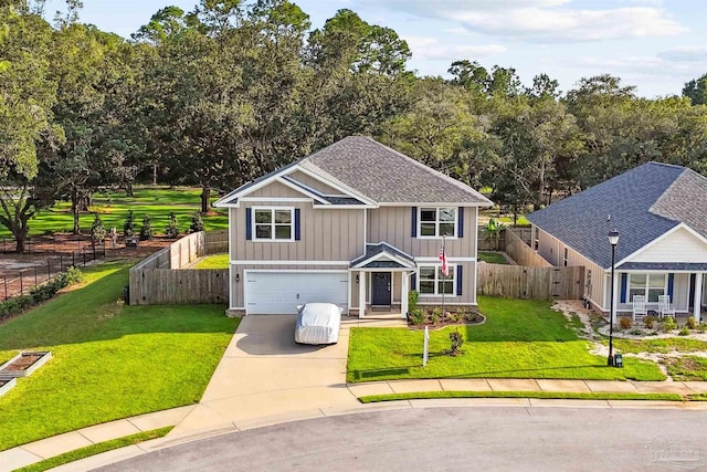 view of front of property featuring a garage and a front yard