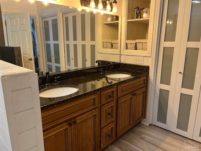 bathroom with hardwood / wood-style flooring and double sink vanity